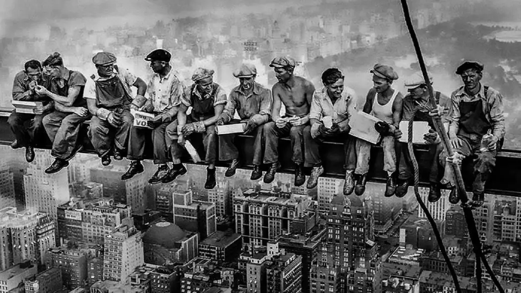People talking to each other, sitting on the beam high on the top of the ground