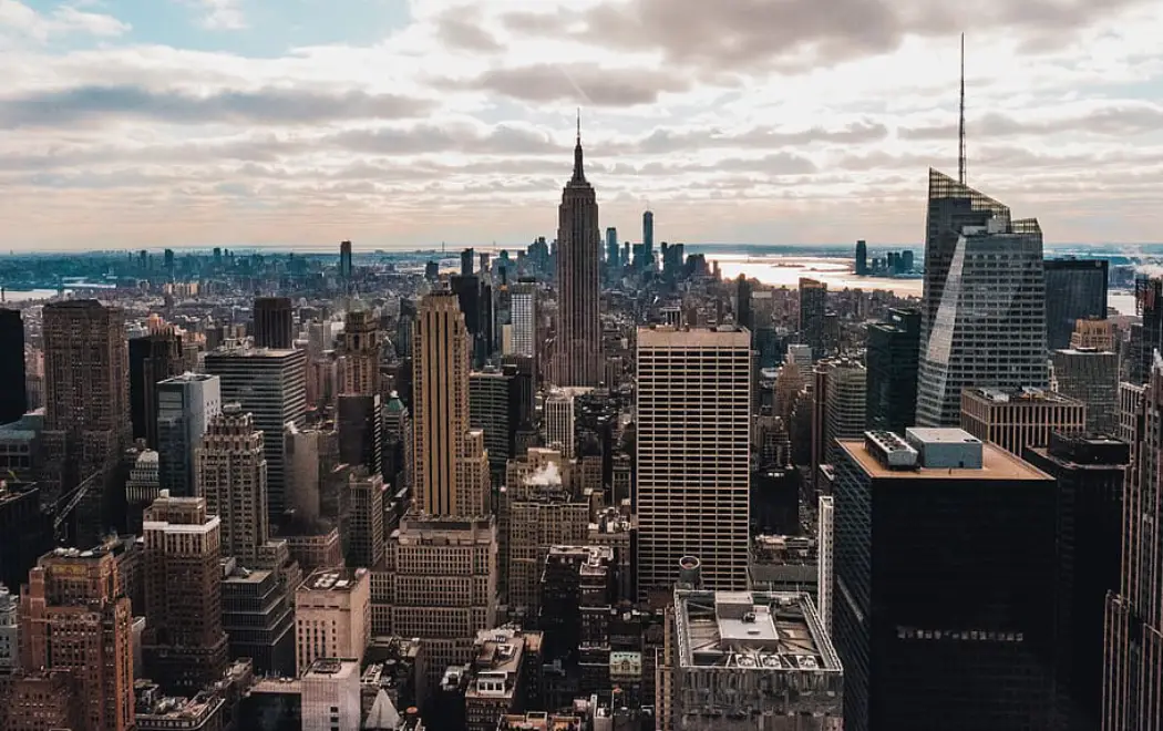 Empire State Building and Manhattan skyline under a partly cloudy sky